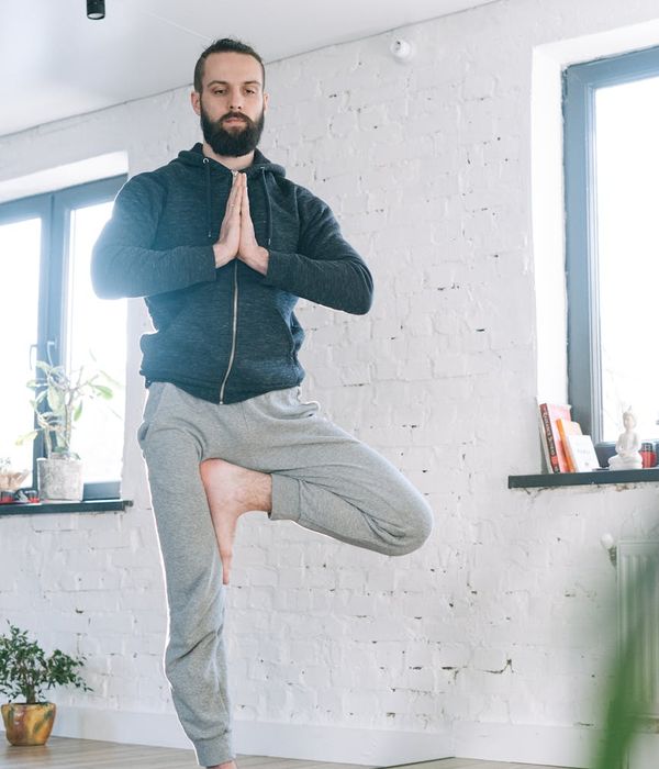 Focused man meditating after a workout session in a calm environment.